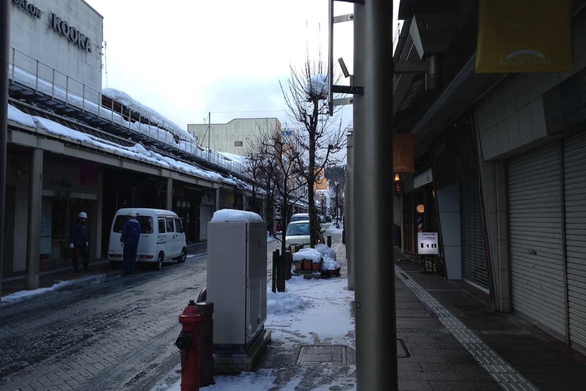 A quiet Takayama shopping street near the Kajibashi crossroads, with everyday shopfronts and no crowds