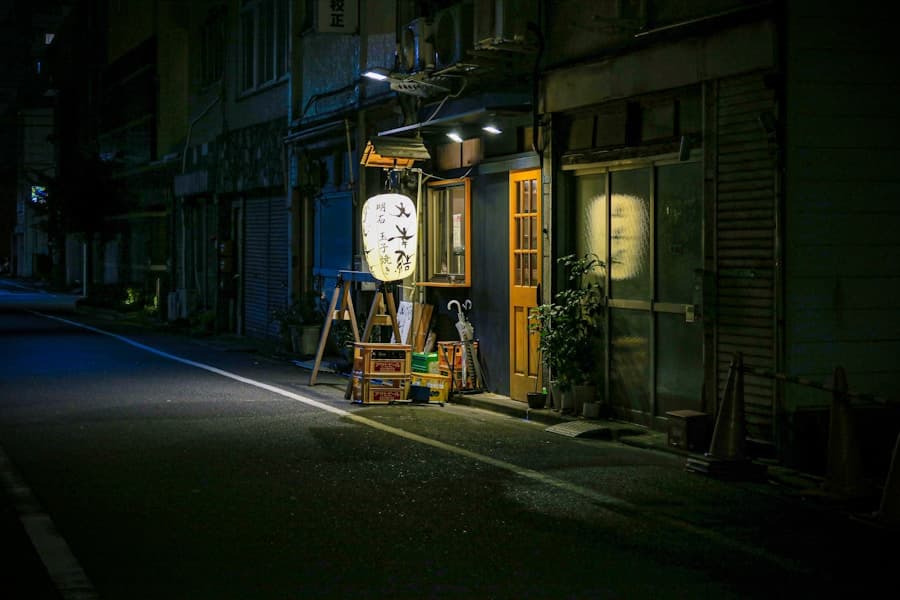 A quiet Osaka side street under morning light, with a traveler walking toward a local shopping arcade entrance.